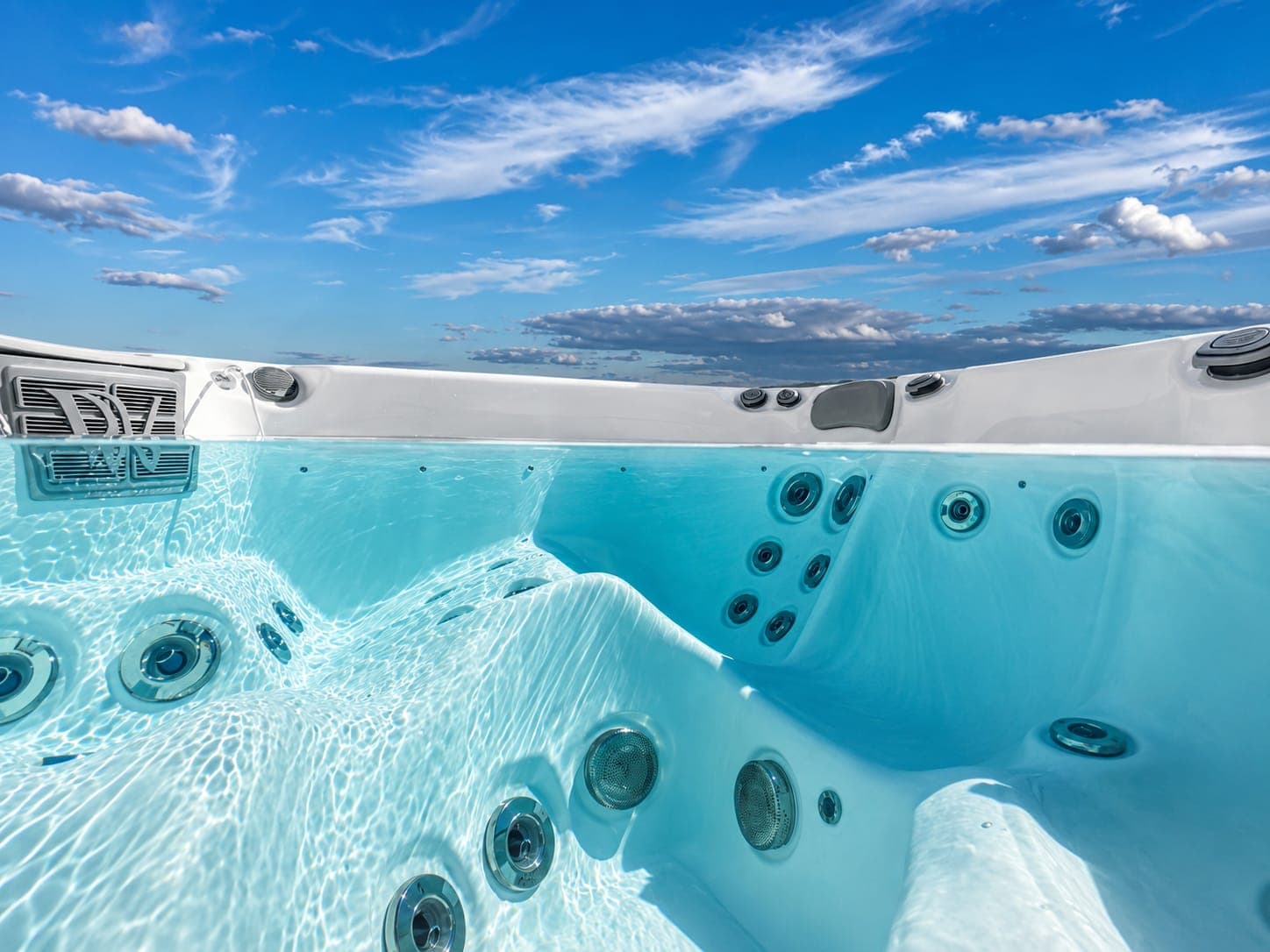 Clean hot tub water being cared for by a technician in warm natural light